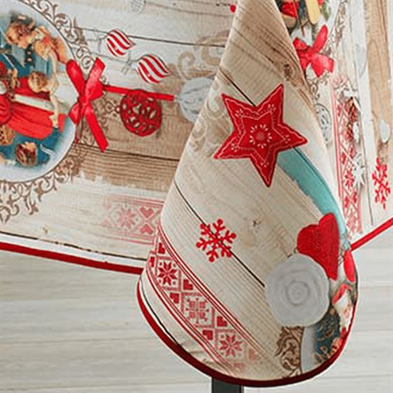 Christmas themed beige tablecloth with Santa Claus and red stars.